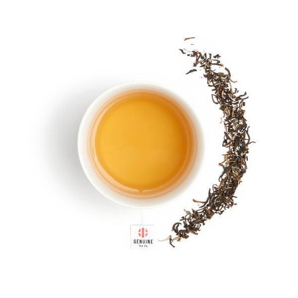 Over head view of brewed Imperial Jasmine tea, surrounded by tea leaves 